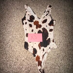 Altar'd State Kids Cow Spot One-Piece Bodysuit in Cream, Brown, Black